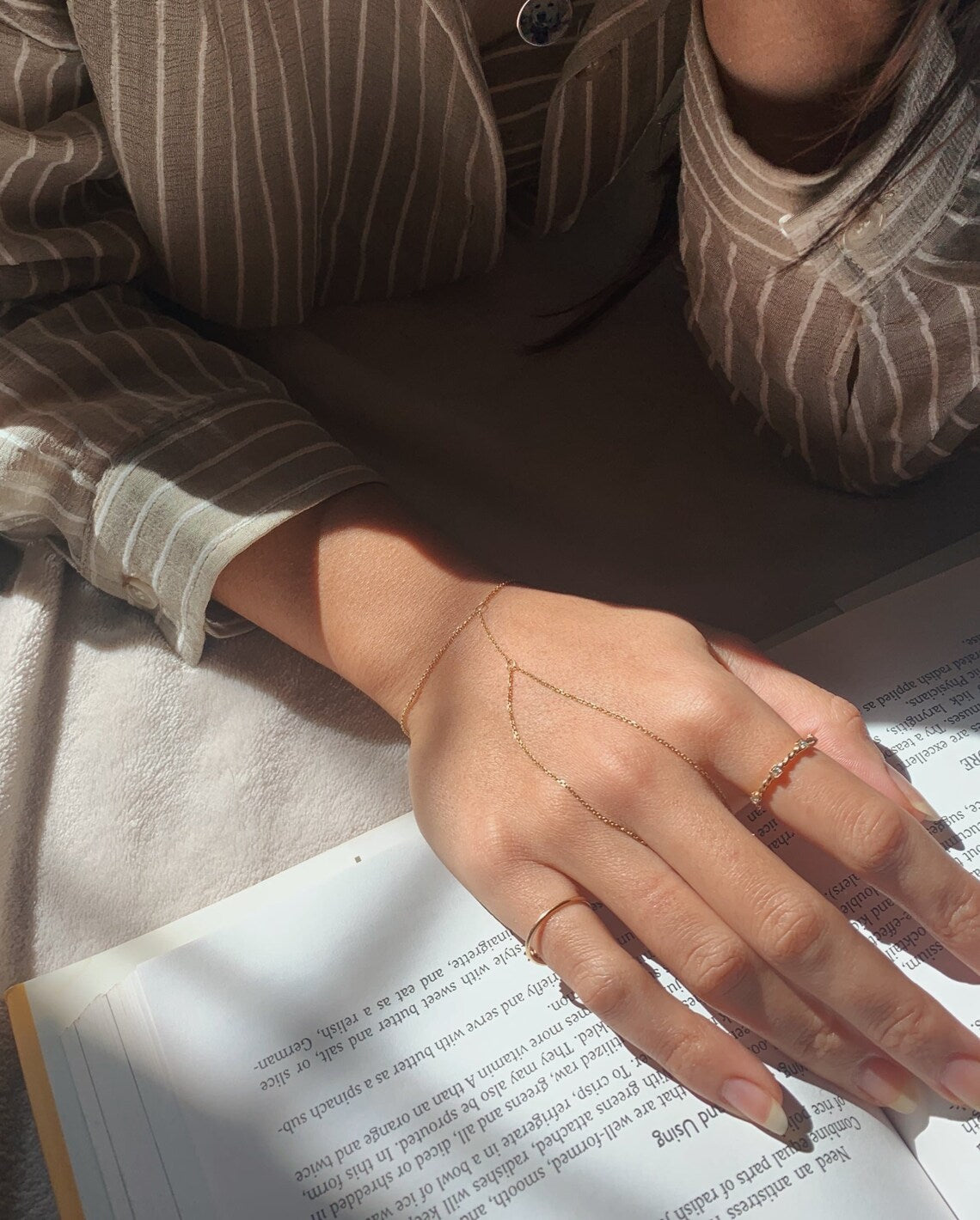 Gold Vertura hand chain styled with rings